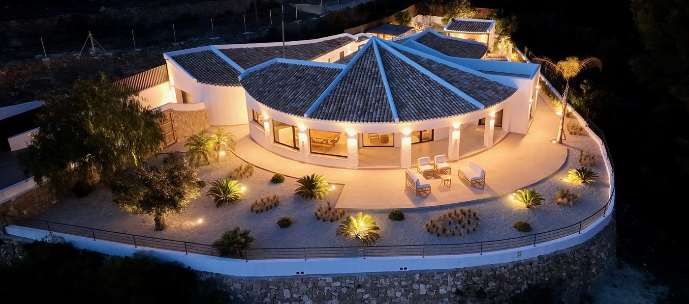Night aerial view of Casa Monte Verde fully illuminated
